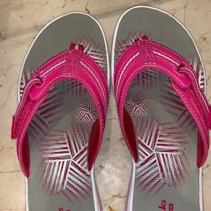 Clark’s flip-flops with velcro tightening strap.